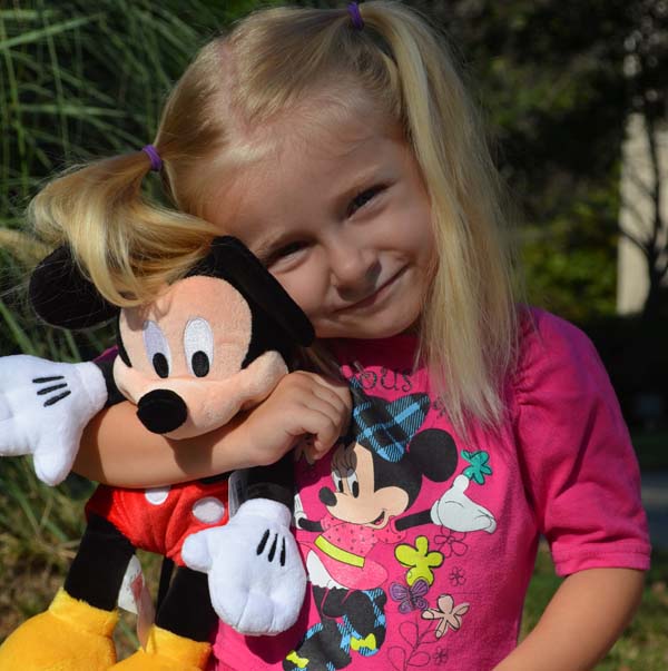 Brooke Griswold hugging a Mickey Mouse plush
